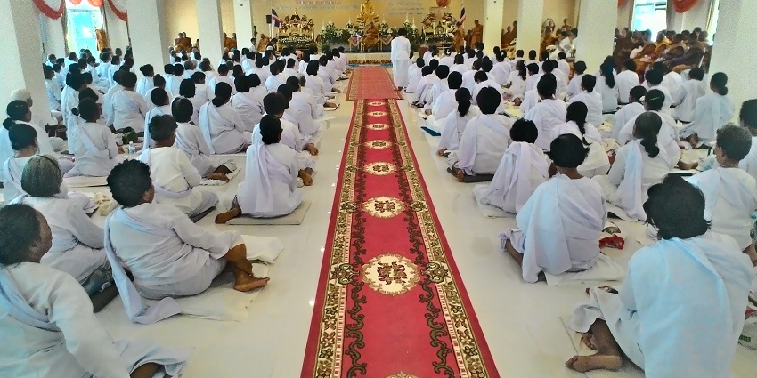 Devotees are gathered at a temple on Visakha Bucha Day to perform the cultural rituals