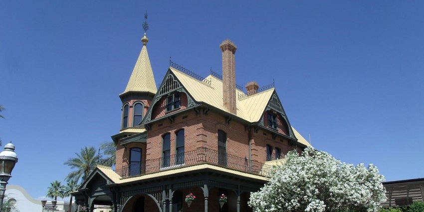 Brick Victorian house with a garden path, resembling the best vintage things to do in Arizona.