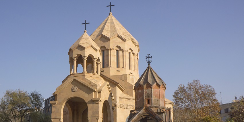 Tiny historic church nestled among Yerevan’s modern urban buildings.