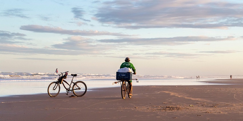 An image showing a cyclist riding near the beach in an area similar to Wakrah Park Beach.