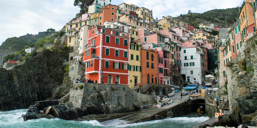Stroll through Riomaggiore’s narrow alleyways filled with vibrant buildings and cosy cafés