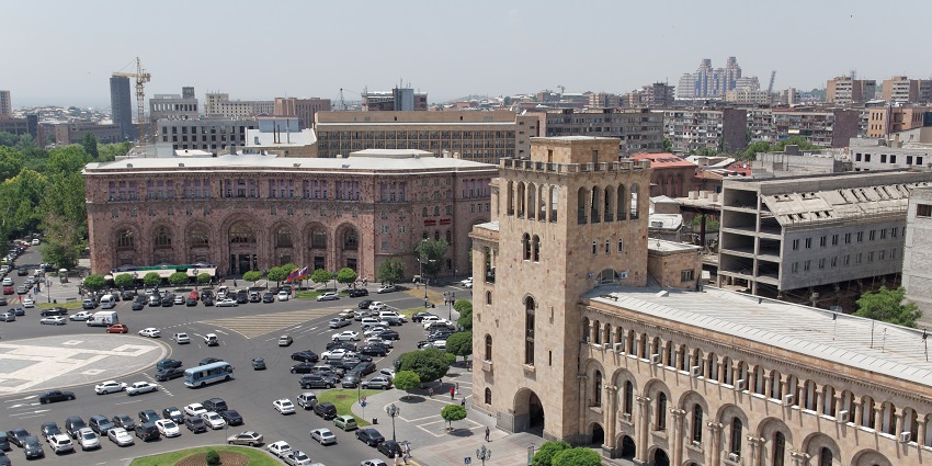 Central plaza with music fountains and surrounding government buildings.
