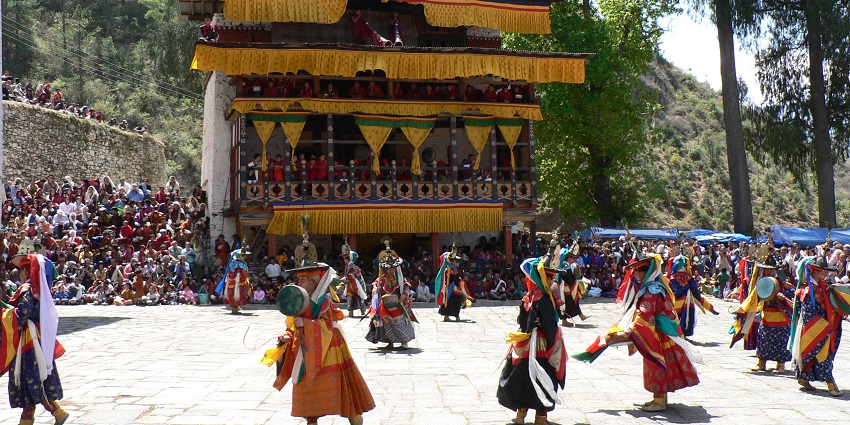 Dancers wearing big masks are performing a religious dance on Wangdue Phodrang Tshechu.