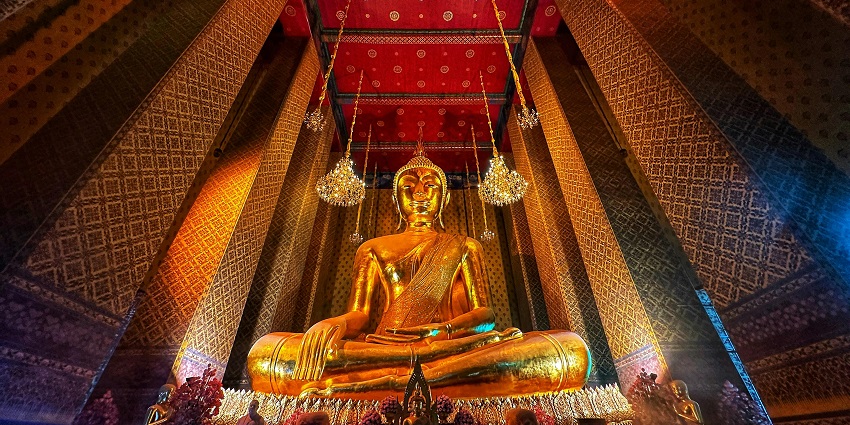 A majestic golden Buddha statue nestled inside the Wat Traimit Witthayaram, Thailand.