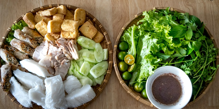 Savour delicious dishes with fried tofu noodles and mixed leaves in Cat Cat Village