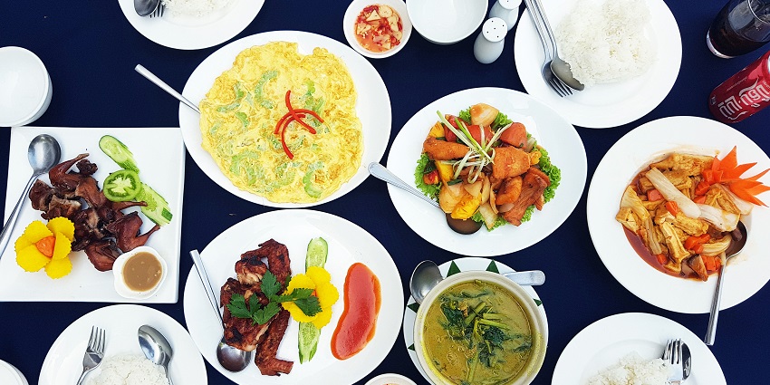 Traditional Khmer meal with rice and curry served near Banteay Kdei complex.