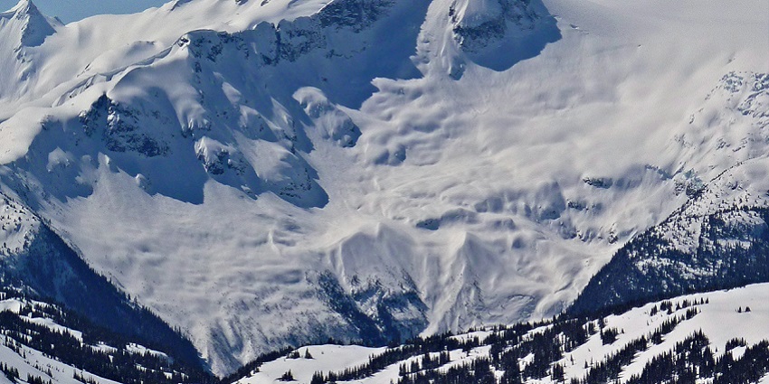 A snow-clad mountain range stands tall amidst the harsh climatic conditions during winter.
