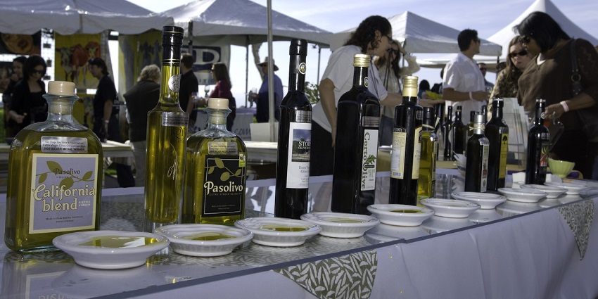 Guests sampling wine under twinkling lights at a culinary festival in Slovenia’s coastal region.