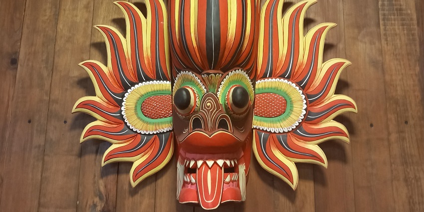 An image of a traditional wooden mask, a popular souvenir to buy in Sri Lanka.