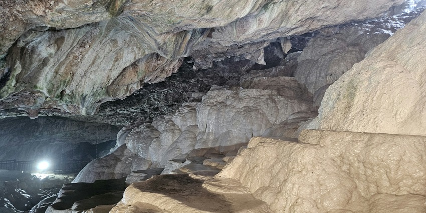 An image of kayakers exploring the massive river in one of the caves in Laos