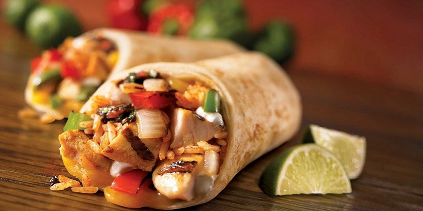 Image of a Yorkshire pudding burrito stuffed with roast beef, gravy, and vegetables.