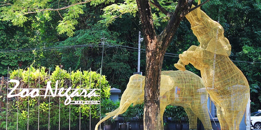 An image of the entrance to Zoo Negara, featuring an elephant sculpture at the gate