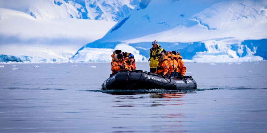 An image of a cruise ship navigating the waters around the Antarctic Peninsula.
