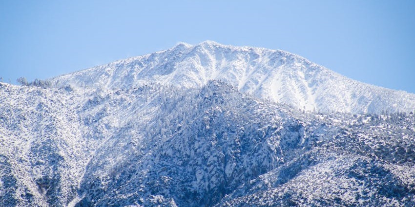 A protected mountain range with forests, snow, and scenic byways.
