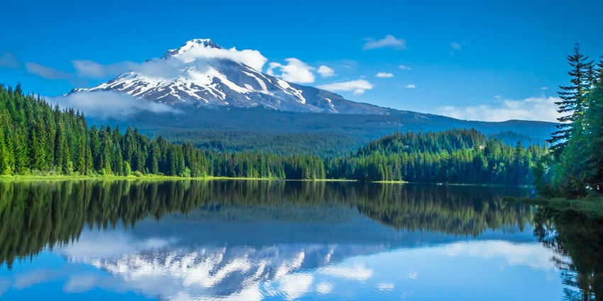 A scenic view of Emigrant Lake with surrounding hills in the back.