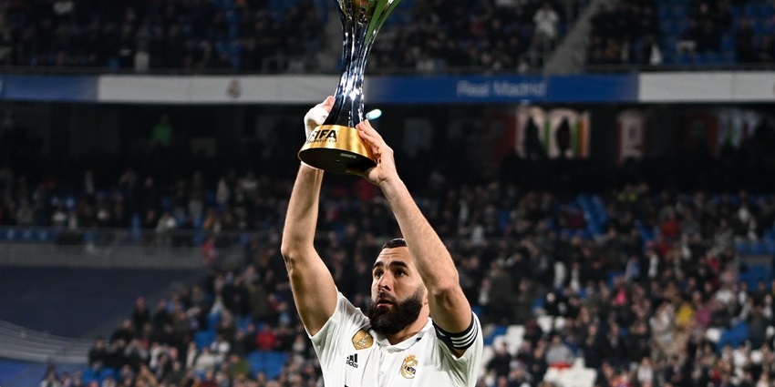 Image of Karim Benzema, a former Real Madrid player, lifting the club world cup trophy.