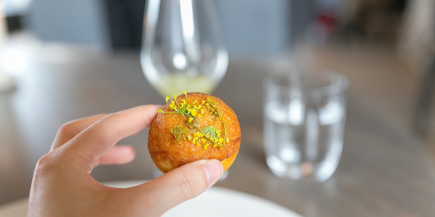 An image of Æbleskiver pancake balls, a traditional Danish Christmas treat with jam and sugar.