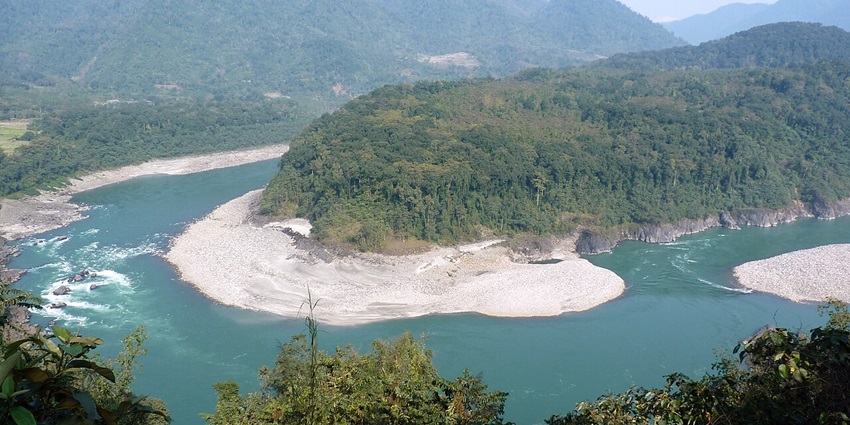 Clear water body of river Siyom in Aalo with sandy shores, green trees and mountains