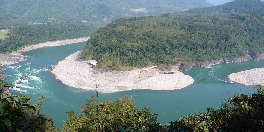 Clear water body of the river Siyom in Aalo with sandy shores, green trees and mountains