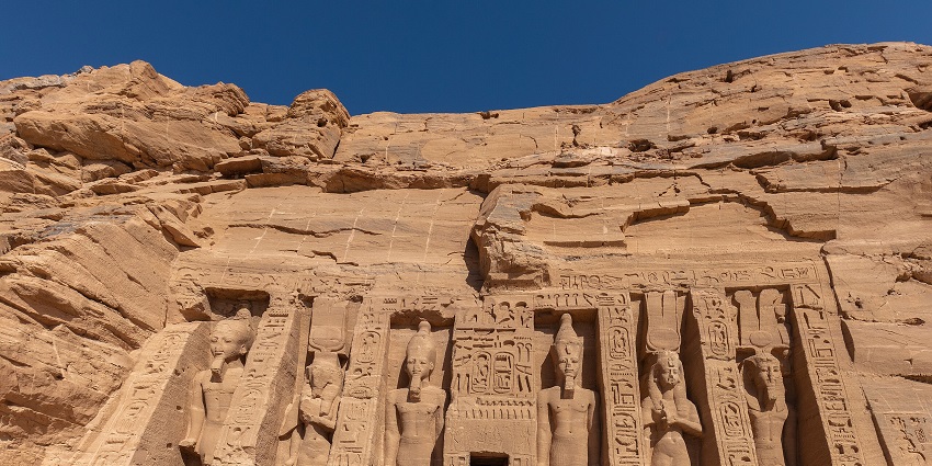 Rock-cut statues at Abu Simbel Temple in Egypt, carved into a sandstone cliff face.