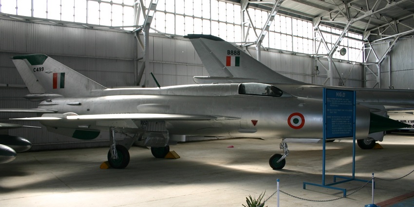 Interior of the Indian Air Force museum with fencing, plants, sign boards and fighter jets, one of the best places to visit in Shillong in January.