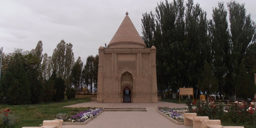 Aisha Bibi Mausoleum with traditional Islamic architecture and flowers on both sides