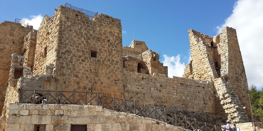 Ajloun Castle, with the old architecture of the castle, people walking, broken walls