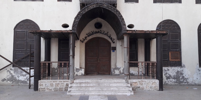Entrance of bait Al balad with Islamic scripture on top of the entrance and closed windows
