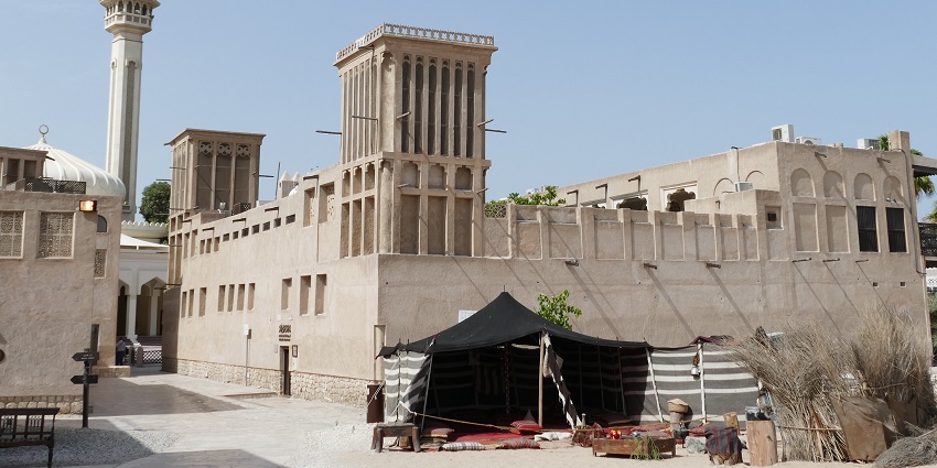 Al Fahidi Historical Neighbourhood with traditional wind towers and heritage buildings.