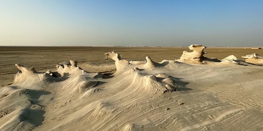 Al Wathba Wetland Reserve with fossil dunes, unique designs and sand plains in the back.