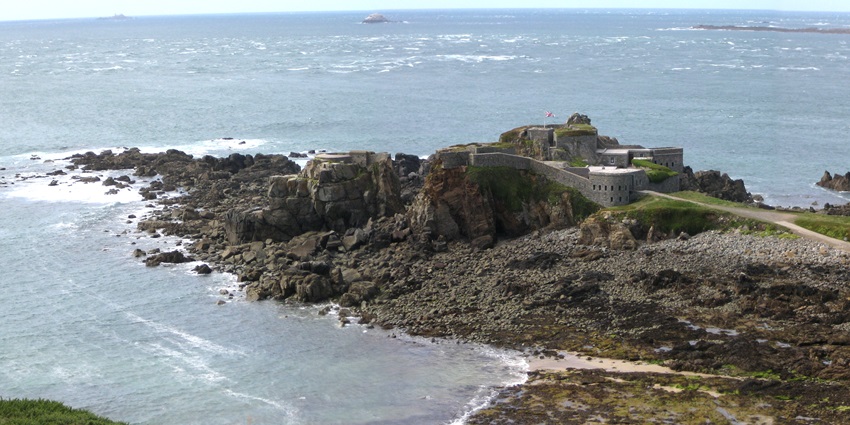 A stone fortress on a rocky peninsula surrounded by sea, an Island in the Channel Islands.