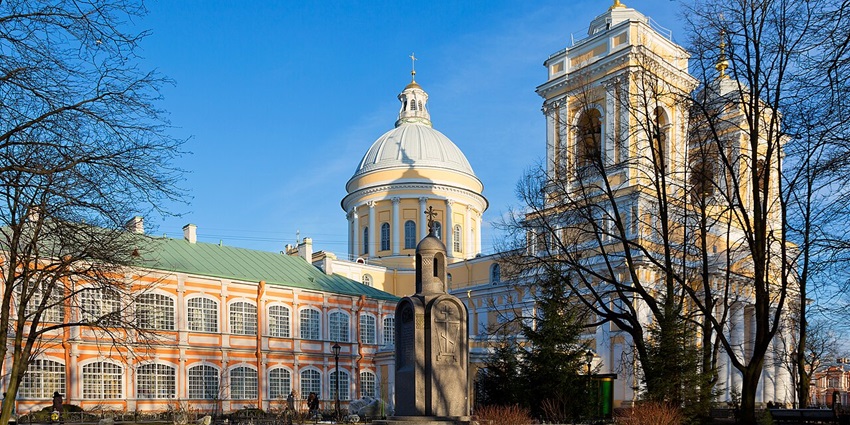 Holy Trinity Cathedral of Alexander Nevsky Lavra, with vibrant buildings and dried trees