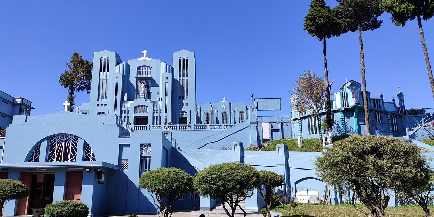 Mary help of Christians cathedral in Shillong with blue architectural building and finely cut trees