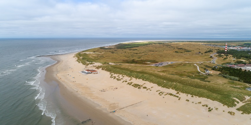 A trail on the sandy shoreline of the Ameland Island, top islands in the Netherlands.