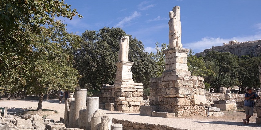 Ancient stone statues and ruins in the Agora of Athens, a historic monument in Greece.