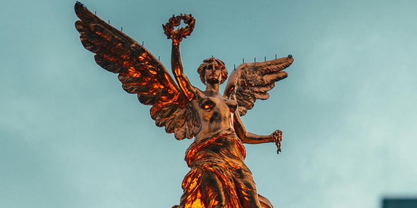 A close-up view of the golden Angel of Independence, an iconic monument in Mexico.