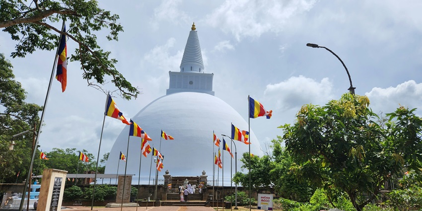 Jetavanaramaya Stupa in Anuradhapura with an orangish brick structure under a blue sky