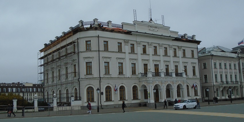 Classic buildings and wide street view with old university facades and passing pedestrians in Kazan centre.