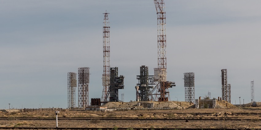 Launch pad of Baikonur Cosmodrome with multiple tall towers and distant small light poles