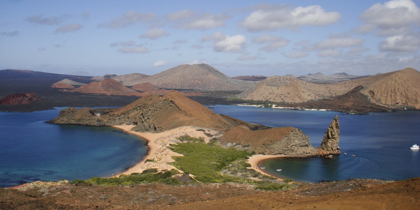 Scenic view of a volcanic island in Ecuador with a narrow isthmus, beaches on either side.