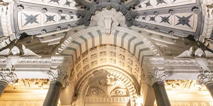Basilica of Notre-Dame de Fourvière with Christian architecture, multiple crosses and statues.