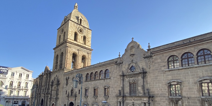 Basilica de San Francisco is bustling with people in front, showcasing vibrant city life.