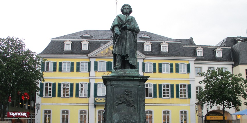 A bronze statue of composer Ludwig van Beethoven stands on a tall pedestal in Mexico.