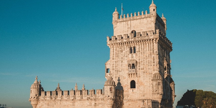 Belem Tower with intricate Manueline architecture overlooking the river, one of the most iconic historical places in Portugal.
