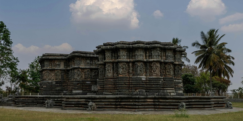 Intricate stone carvings on temple walls showcase detailed Hoysala architecture in Halebidu.