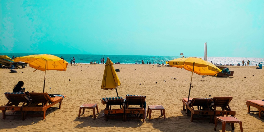 Tiruchendur Beach with gentle waves, golden sands, and a serene coastal view.
