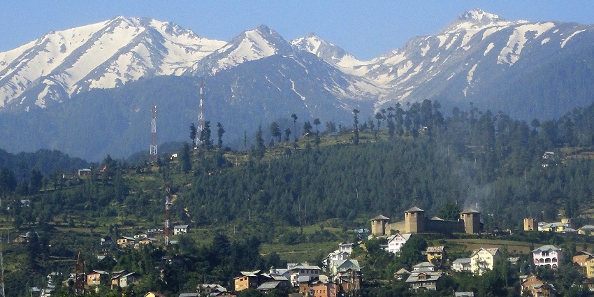 Scenic view of Bhadarwah valley with green hills, terraced fields, and scattered houses