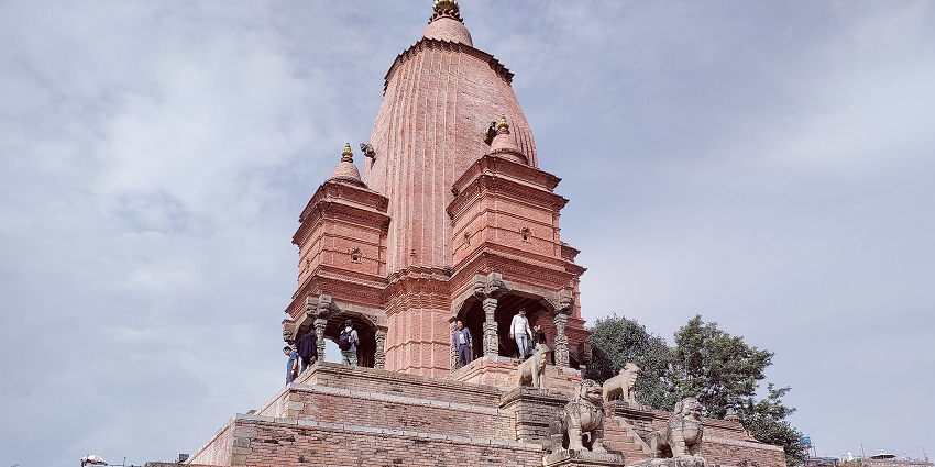 View of Bhaktapur Durbar Square with a few visitors, showcasing its traditional architecture.
