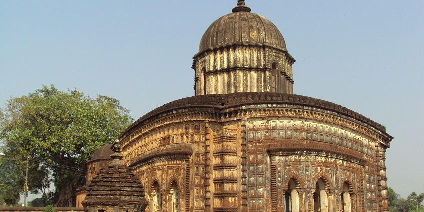 Radhashyam Temple at Bishnupur showcases ornate terracotta carvings under daylight.