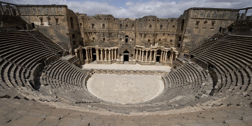 Bosra Roman theatre with old ruined architecture, sitting area for people, one of the historical places in Syria.